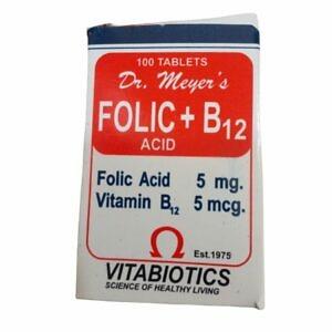 A bottle of Dr. Meyers Folic and B12 Tablets, containing 100 tablets, is shown against a clean background. The label clearly displays the product name, highlighting the combination of folic acid and vitamin B12, designed to support overall health and well-being. The packaging is straightforward, emphasizing the key nutrients and the quantity of tablets included for dietary supplementation.