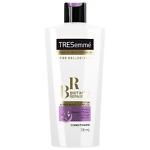 A 700ml bottle of TRESemmé Biotin Repair 7 Conditioner with a sleek white and purple design. The bottle features the TRESemmé logo and highlights its biotin-infused formula, designed to repair damaged, brittle, and weak hair. The label emphasizes its ability to strengthen, protect, and restore hair affected by heat, styling, coloring, and environmental damage, making it ideal for dry and damaged hair types.